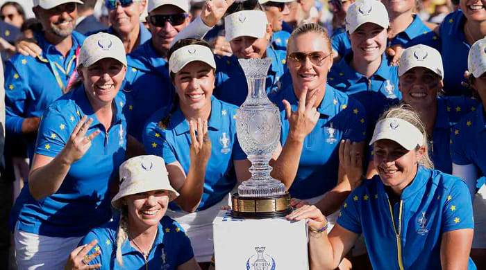 Europe's Solheim Cup team members pose with the trophy after winning in Finca Cortesin, near Casares, southern Spain, Sunday, Sept. 24, 2023.